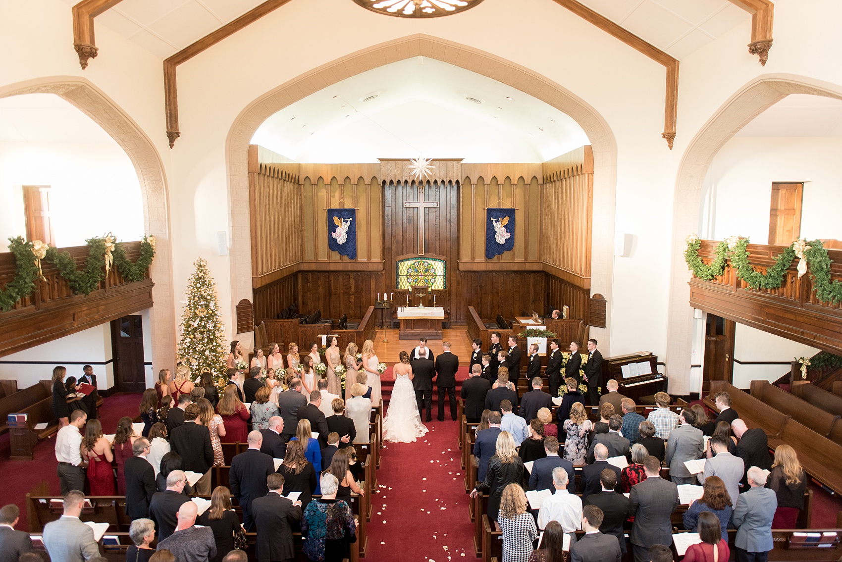 Pictures from a Christmas inspired wedding in downtown Raleigh, North Carolina by Mikkel Paige Photography. The couple's December ceremony was at a nearby Hillyer Memorial Christian Church and reception at The Stockroom at 230. Click through to see more ideas of their wedding party and pictures of the beautiful reception celebration, with a green and gold color palette. #mikkelpaige #raleighweddingphotographer #downtownRaleigh #weddingparty #winterwedding #greenandgoldwedding