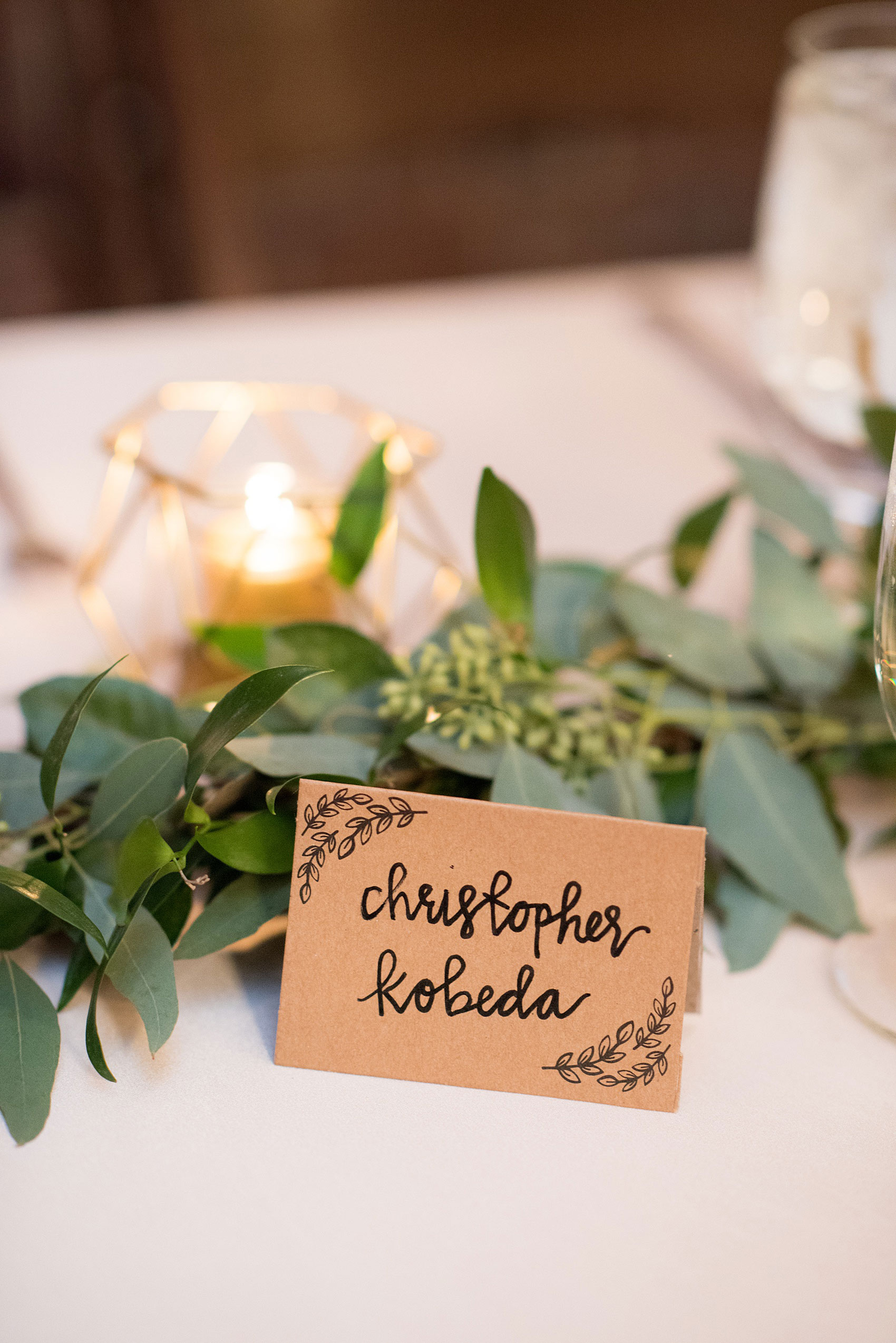 Pictures from a Christmas inspired wedding in downtown Raleigh, North Carolina by Mikkel Paige Photography. The bride and groom had a reception at The Stockroom at 230 with green and gold decor details and pink linens. Kraft paper place cards were at the head table. Mercury glass held warm candles and vases cranberry centerpieces. Click through for more ideas from their beautiful celebration! #mikkelpaige #raleighweddingphotographer #downtownRaleigh #greenandgoldwedding #Christmaswedding