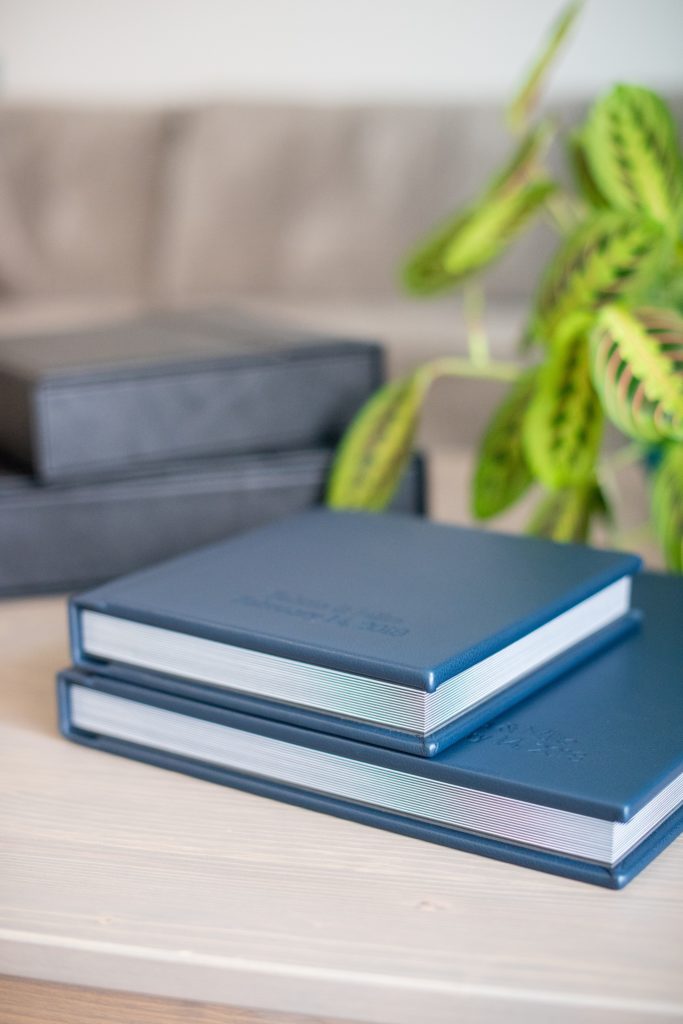 Photos from a winter wedding at Central Park Loeb Boathouse in NYC, by Mikkel Paige Photography, are beautifully displayed. The bride and groom chose a navy blue leather 12x12" album with spine and cover debossing to remember their day. #mikkelpaige #centralparkwedding #loebboathousewedding #NYCweddingphotographer #navyblueweddingalbum #parentalbums