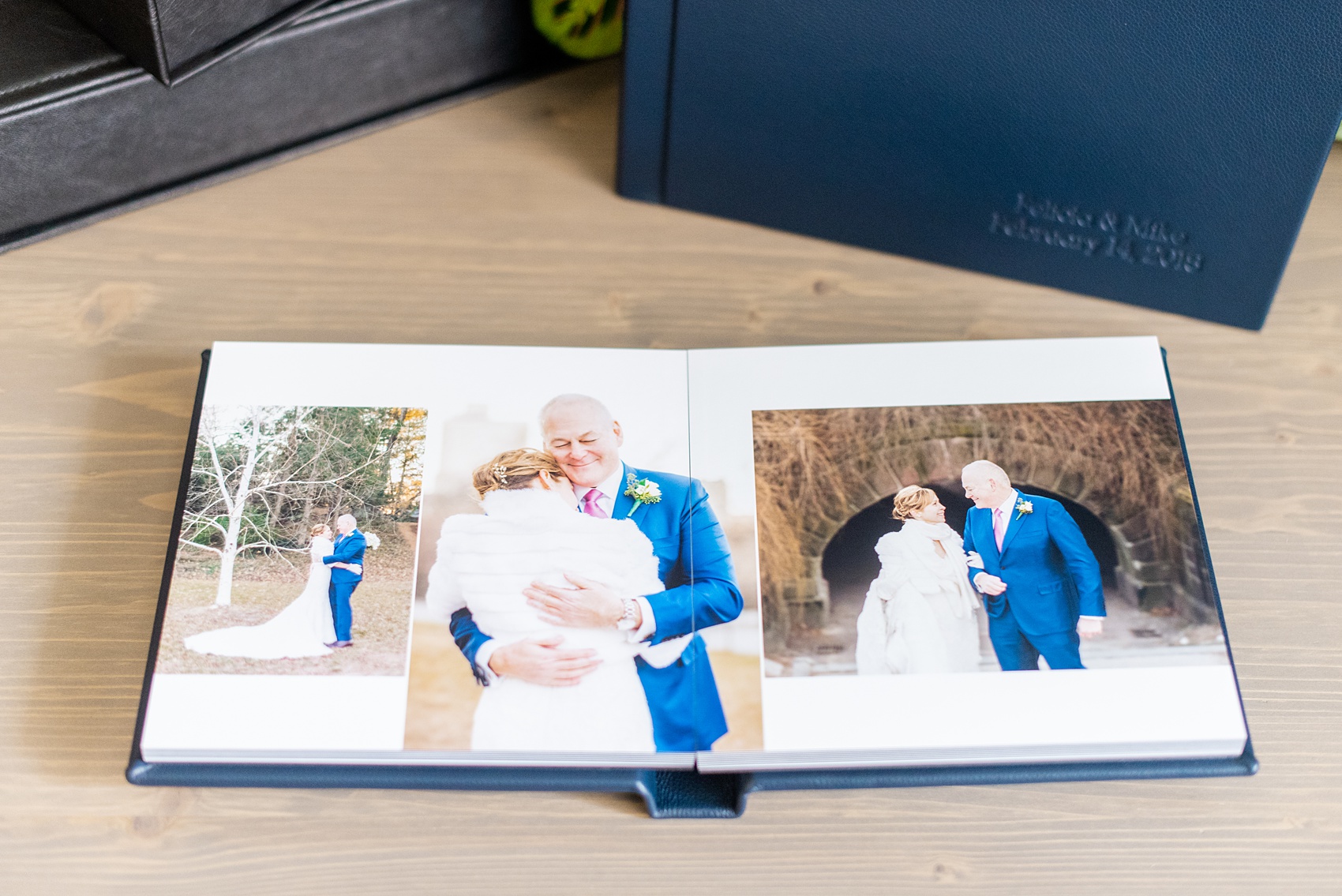 Photos from a winter wedding at Central Park Loeb Boathouse in NYC, by Mikkel Paige Photography, are beautifully displayed. The bride and groom chose a navy blue leather 12x12" album with spine and cover debossing to remember their day. #mikkelpaige #centralparkwedding #loebboathousewedding #NYCweddingphotographer #navyblueweddingalbum #parentalbums