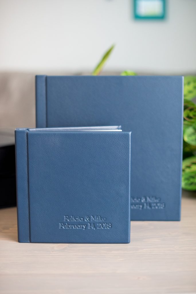 Photos from a winter wedding at Central Park Loeb Boathouse in NYC, by Mikkel Paige Photography, are beautifully displayed. The bride and groom chose a navy blue leather 12x12" album with spine and cover debossing to remember their day. #mikkelpaige #centralparkwedding #loebboathousewedding #NYCweddingphotographer #navyblueweddingalbum #parentalbums