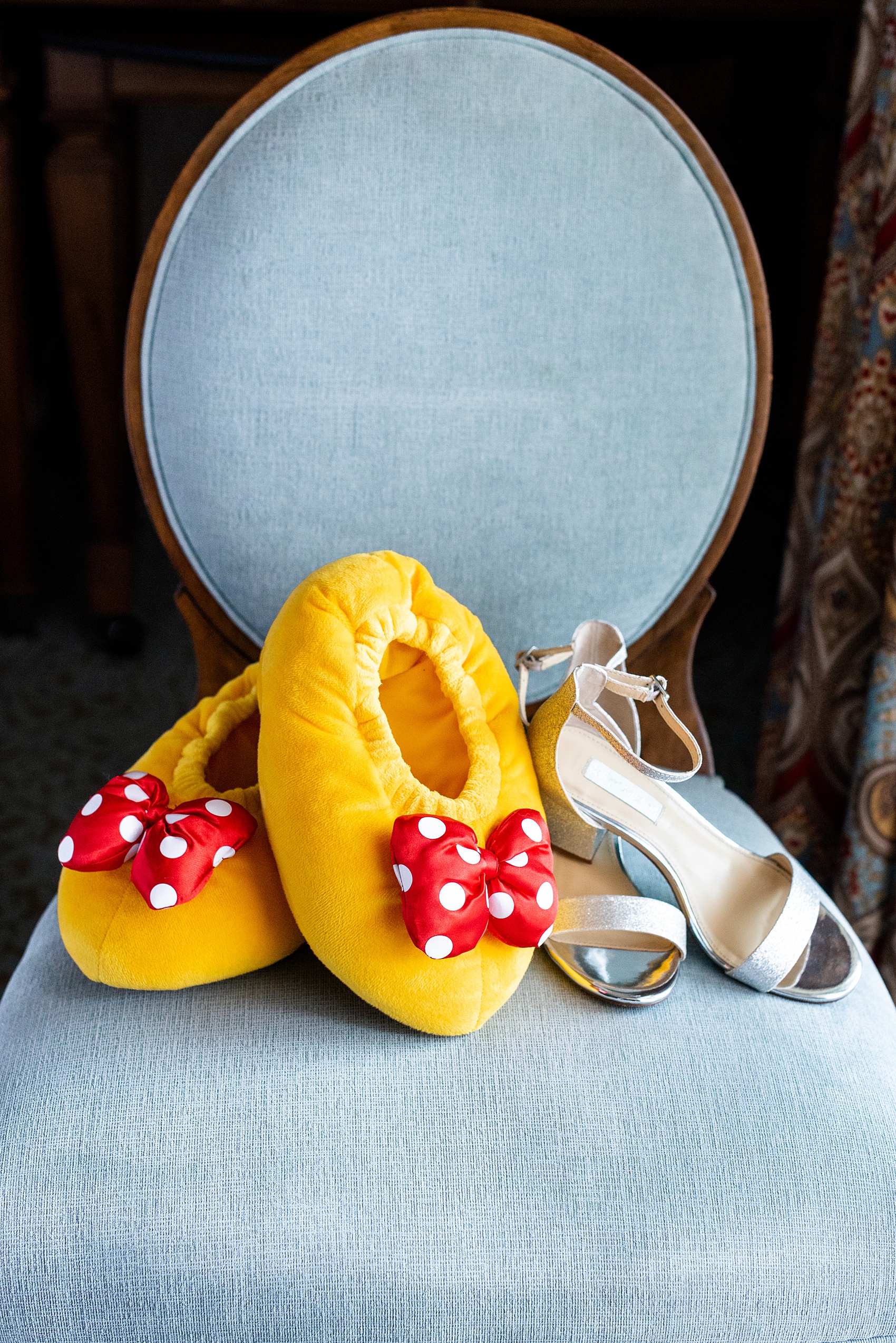 Photographs of a Walt Disney World wedding by Mikkel Paige Photography. The bride got ready at the Grand Floridian and had silver glitter shoes, worthy of a princess! She also wore Minnie Mouse slippers to get ready for the day and had a Cinderella quote for her dust bag shoe carrier. #disneywedding #disneybride #waltdisneyworld #DisneyWorldWedding #minniemouseslippers #bridalshoes #minniemouse