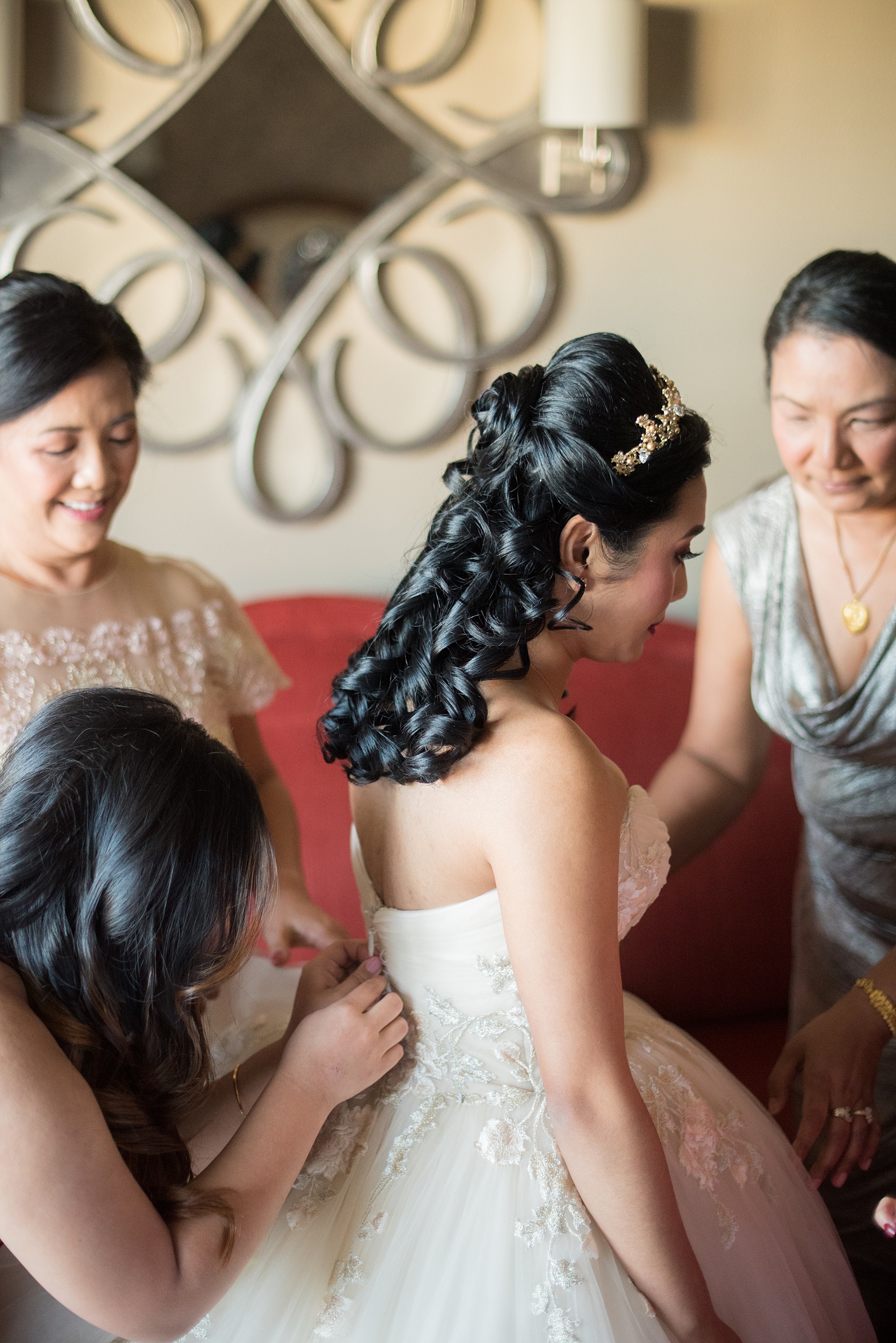 Photographs of a Walt Disney World bride by Mikkel Paige Photography. As a lover of Beauty and the Beast, the bride wove details from the classic Disney film into her wedding. Her beautiful rose embroidered dress was befitting of a princess. She got ready for her day at the dream resort, the Grand Floridian. Her hair was twisted into a fun, rose bun. #disneywedding #disneybride #waltdisneyworld #DisneyWorldWedding