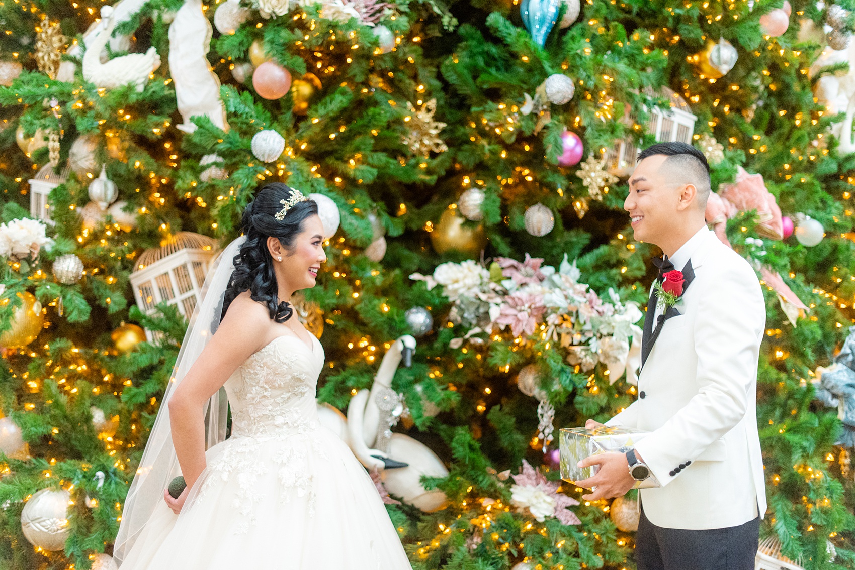 Walt Disney World photographs by Mikkel Paige Photography. The bride and groom had December pictures at the Grand Floridian Resort, Wedding Pavilion and Contemporary Hotel. The groom gifted his bride a Beauty and the Beast glass dome with a rose, befitting of a princess. #disneywedding #disneybride #waltdisneyworld #DisneyWorldWedding #giftexchange #BeautyandtheBeast