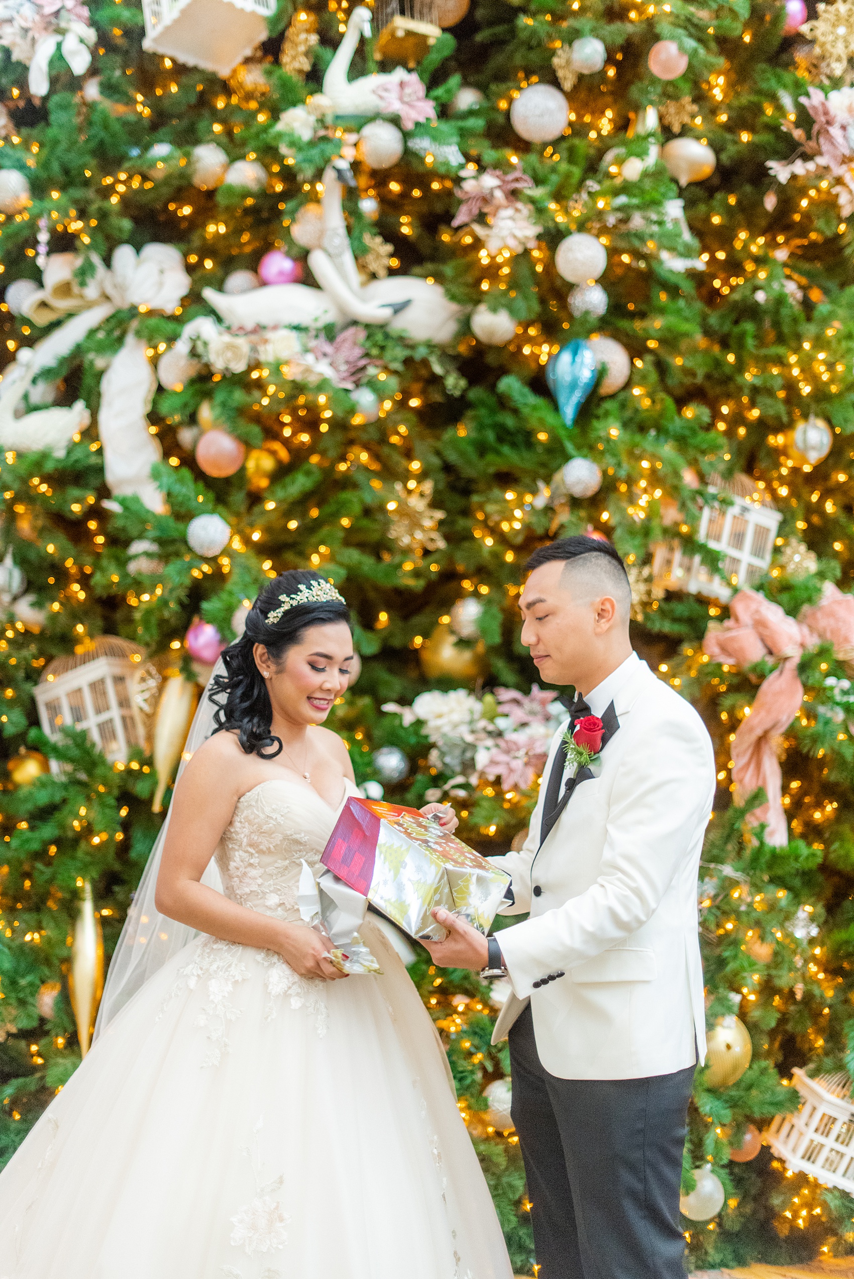 Walt Disney World photographs by Mikkel Paige Photography. The bride and groom had December pictures at the Grand Floridian Resort, Wedding Pavilion and Contemporary Hotel. The groom gifted his bride a Beauty and the Beast glass dome with a rose, befitting of a princess. #disneywedding #disneybride #waltdisneyworld #DisneyWorldWedding #giftexchange #BeautyandtheBeast