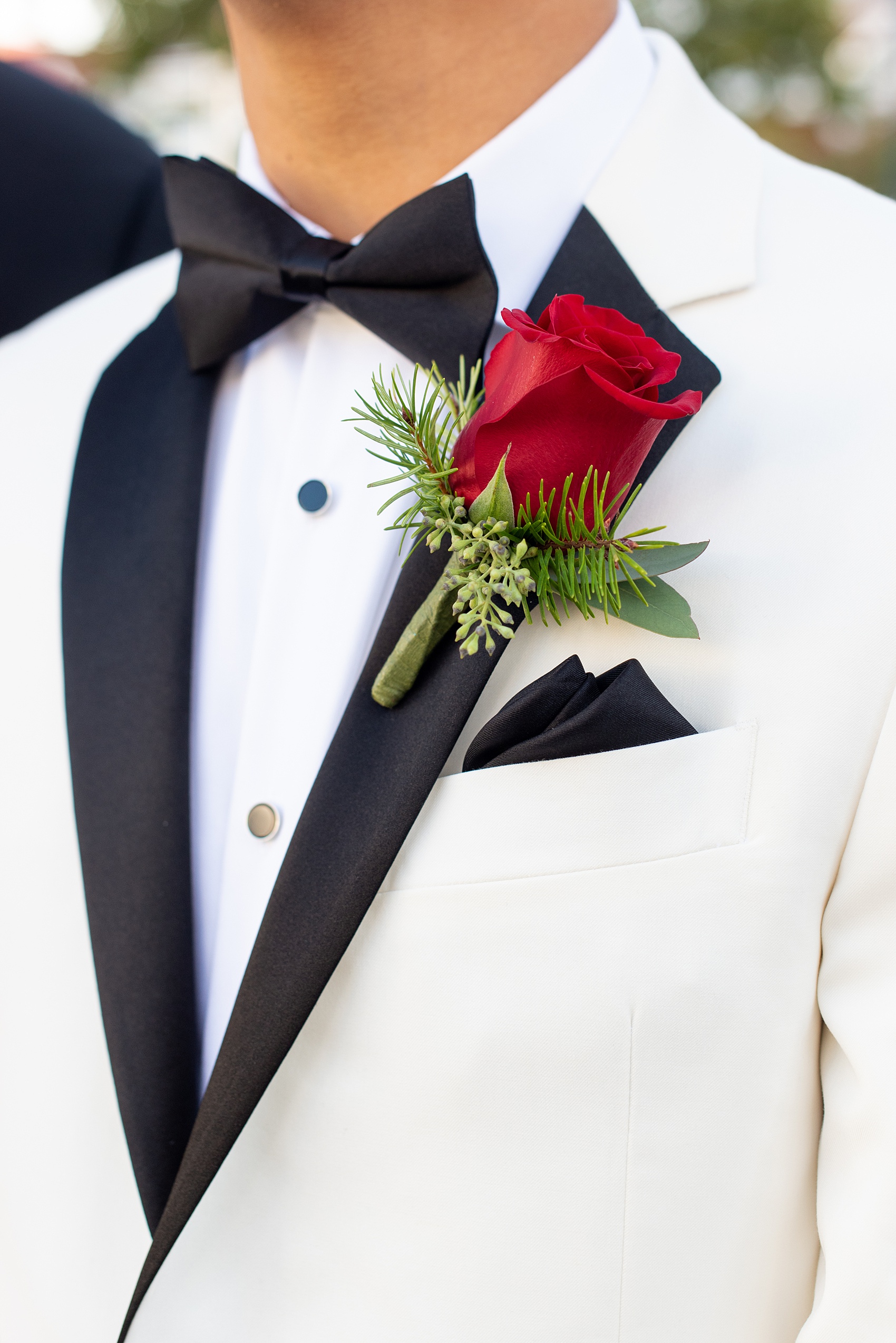 Photographs of a Walt Disney World groom by Mikkel Paige Photography. As a lover of Marvel comics, he wove a small detail from Iron Man into his white tuxedo with gold and red cufflinks. He got ready for his day at the dream resort, the Grand Floridian, with his groomsmen and wore a red rose boutonniere for his bride’s love of a Beauty and the Beast theme. #disneywedding #disneybride #waltdisneyworld #DisneyWorldWedding