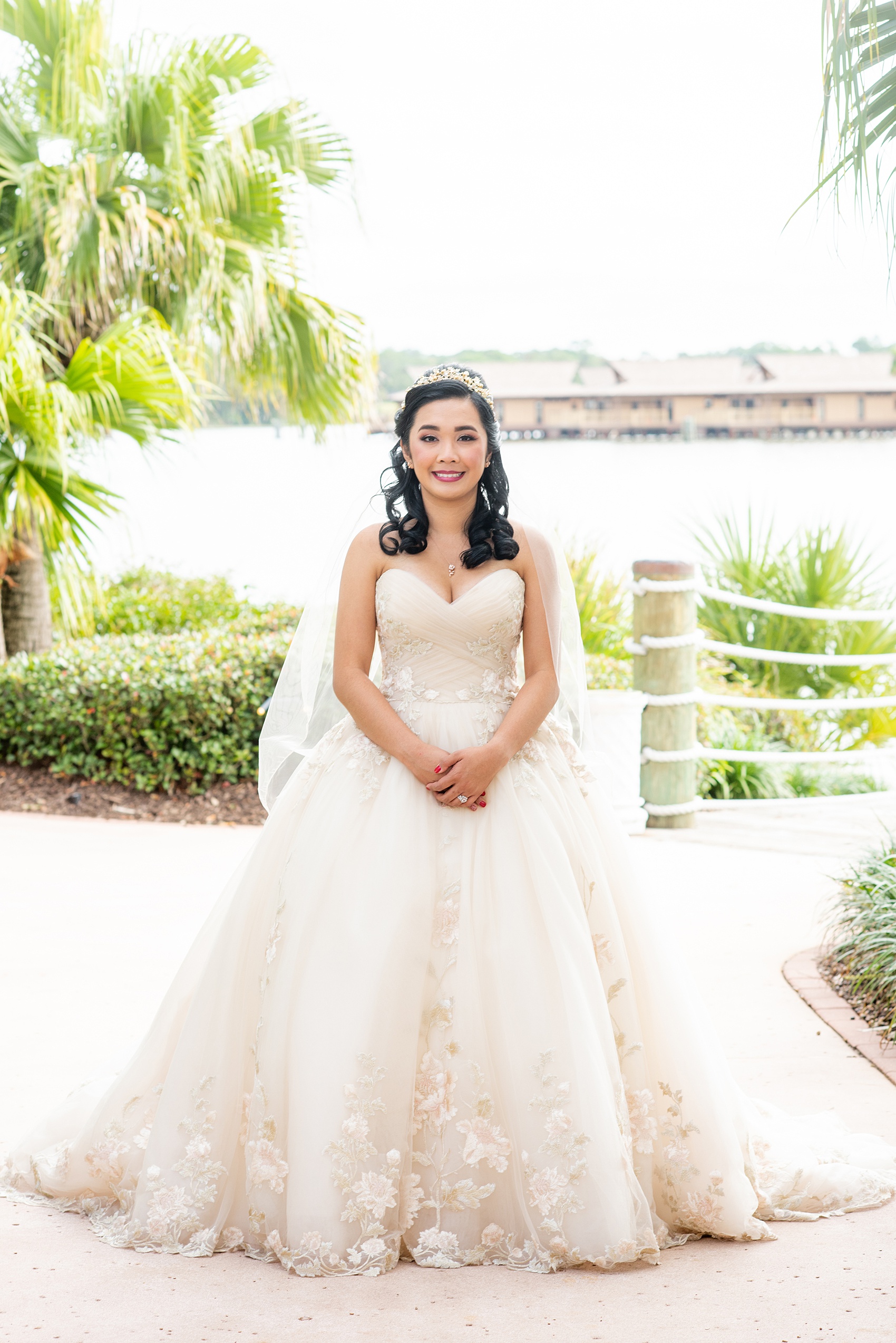 Photographs of a Walt Disney World bride by Mikkel Paige Photography. As a lover of Beauty and the Beast, the bride wove details from the classic Disney film into her wedding. Her beautiful rose embroidered dress was befitting of a princess. She got ready for her day at the dream resort, the Grand Floridian. Her hair was twisted into a fun, rose bun. #disneywedding #disneybride #waltdisneyworld #DisneyWorldWedding