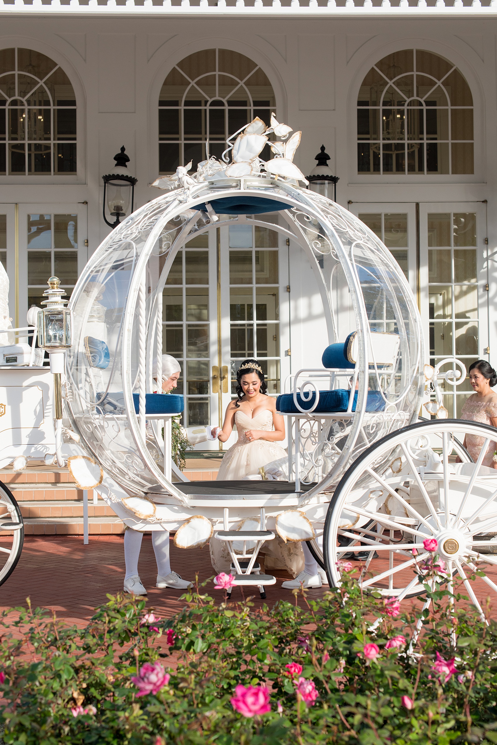 Walt Disney World photographs by Mikkel Paige Photography. The bride and groom celebrated to their ceremony in style in Cinderella’s Glass Coach with white ponies. They took pictures at the Grand Floridian Resort and Wedding Pavilion with this awesome transportation. #disneywedding #disneybride #waltdisneyworld #DisneyWorldWedding #CinderellaCarriage #GlassCoach