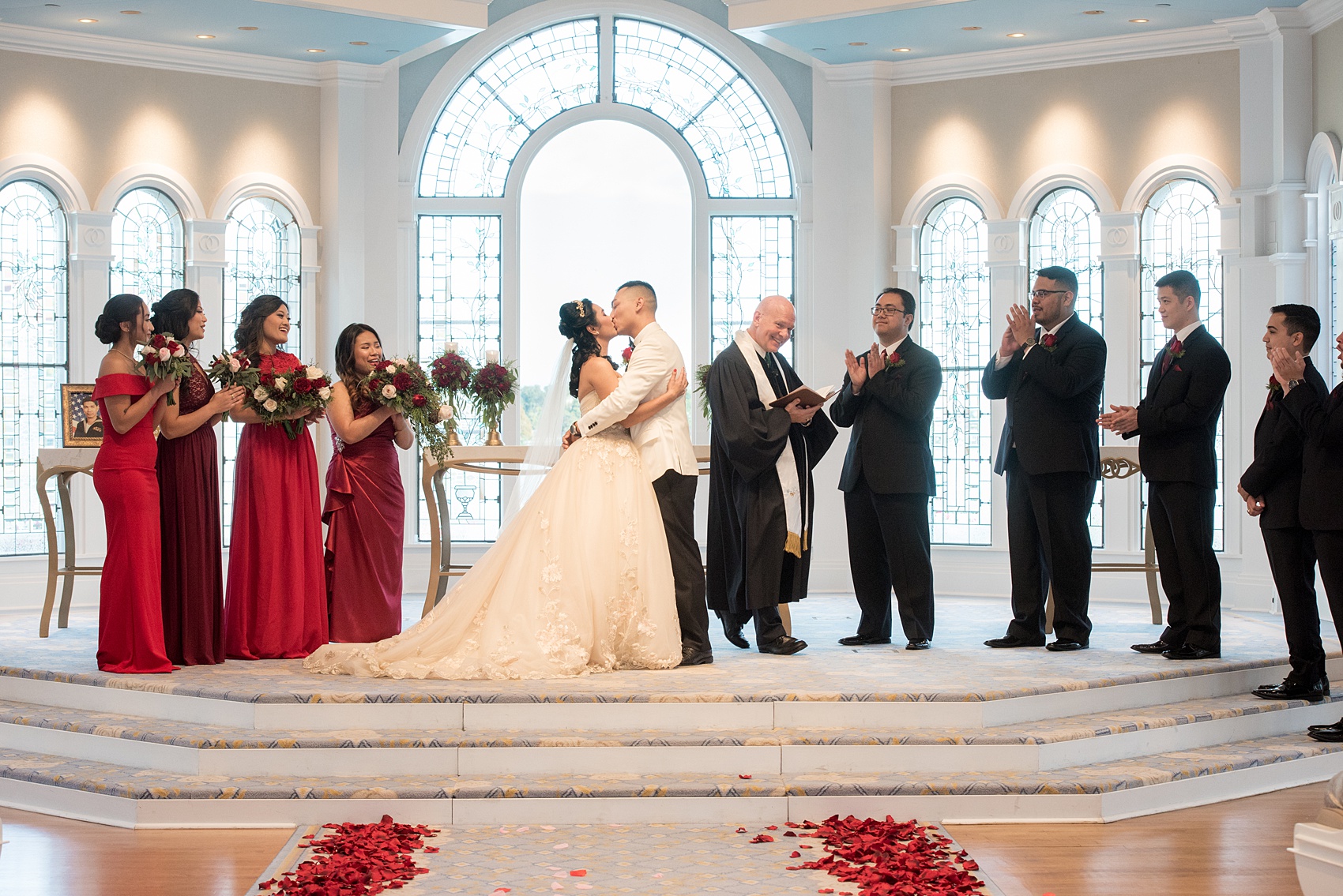 Photographs of a Walt Disney World wedding by Mikkel Paige Photography will give you ideas for a tasteful Beauty and the Beast theme. There was a glass dome with a red rose inside at the start of the ceremony with red rose petals scattered down the aisle for a small, intimate guest list at the Wedding Pavilion next to the Grand Floridian resort. #disneywedding #disneybride #waltdisneyworld #DisneyWorldWedding #DisneyCeremony #DisneyWorldWeddingPavilion