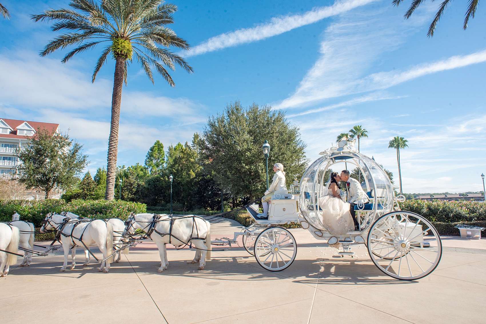 Walt Disney World photographs by Mikkel Paige Photography. The bride and groom celebrated to their ceremony in style in Cinderella’s Glass Coach with white ponies. They took pictures at the Grand Floridian Resort and Wedding Pavilion with this awesome transportation. #disneywedding #disneybride #waltdisneyworld #DisneyWorldWedding #CinderellaCarriage #GlassCoach