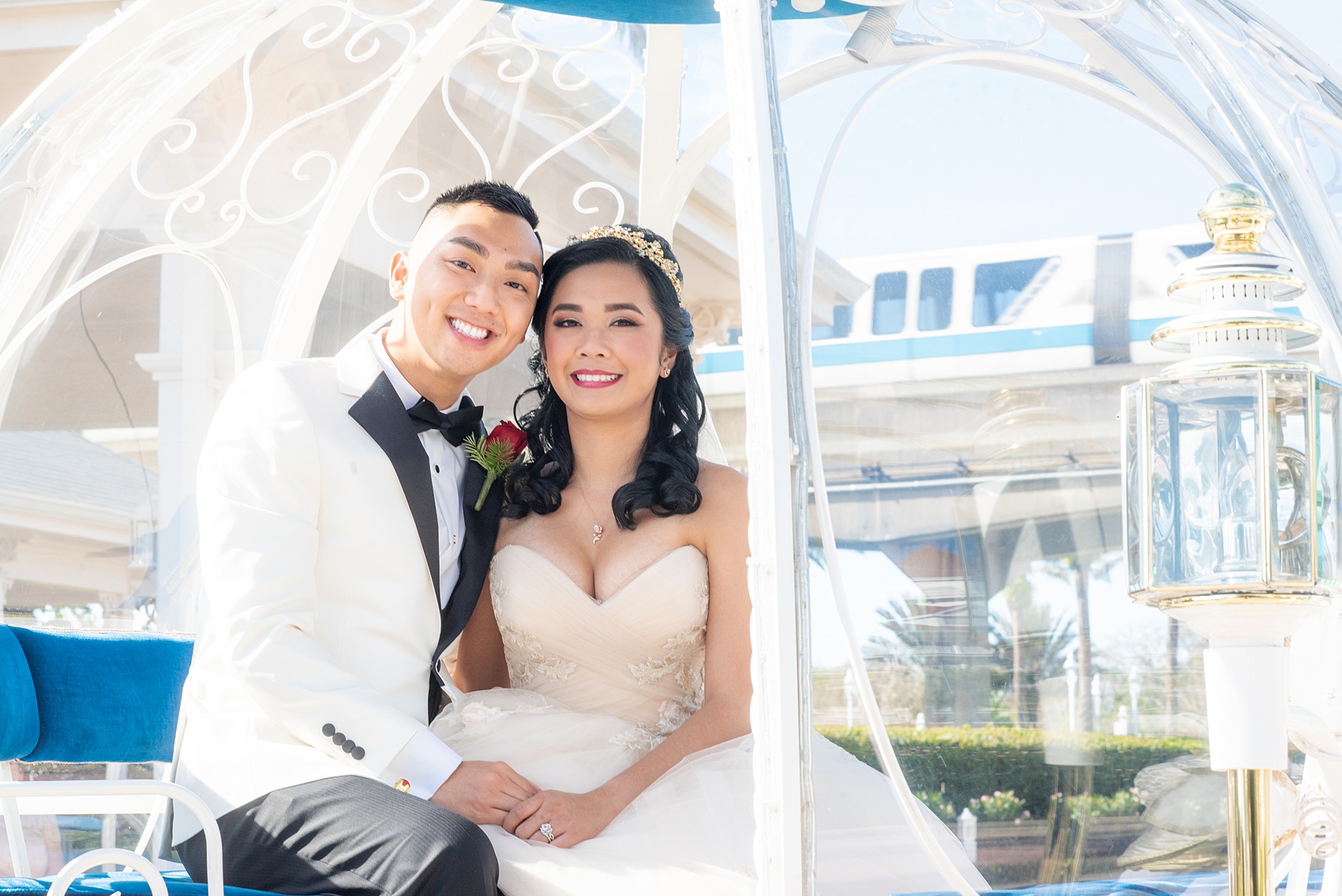 Walt Disney World photographs by Mikkel Paige Photography. The bride and groom celebrated to their ceremony in style in Cinderella’s Glass Coach with white ponies. They took pictures at the Grand Floridian Resort and Wedding Pavilion with this awesome transportation. #disneywedding #disneybride #waltdisneyworld #DisneyWorldWedding #CinderellaCarriage #GlassCoach