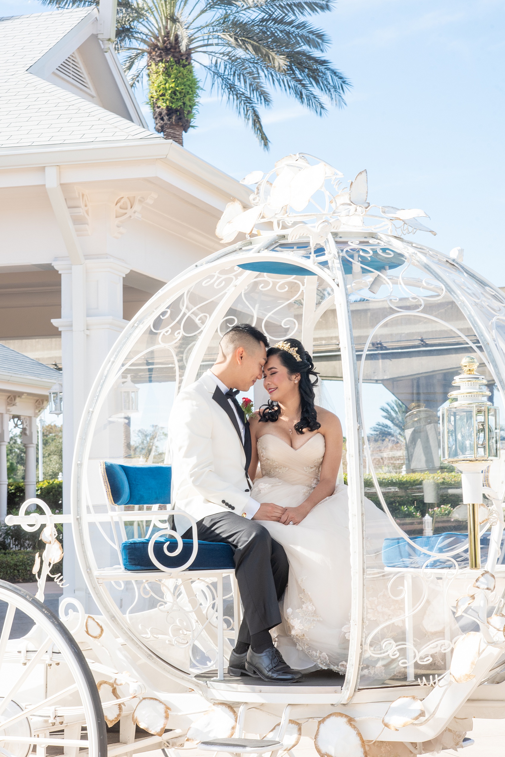 Walt Disney World photographs by Mikkel Paige Photography. The bride and groom celebrated to their ceremony in style in Cinderella’s Glass Coach with white ponies. They took pictures at the Grand Floridian Resort and Wedding Pavilion with this awesome transportation. #disneywedding #disneybride #waltdisneyworld #DisneyWorldWedding #CinderellaCarriage #GlassCoach