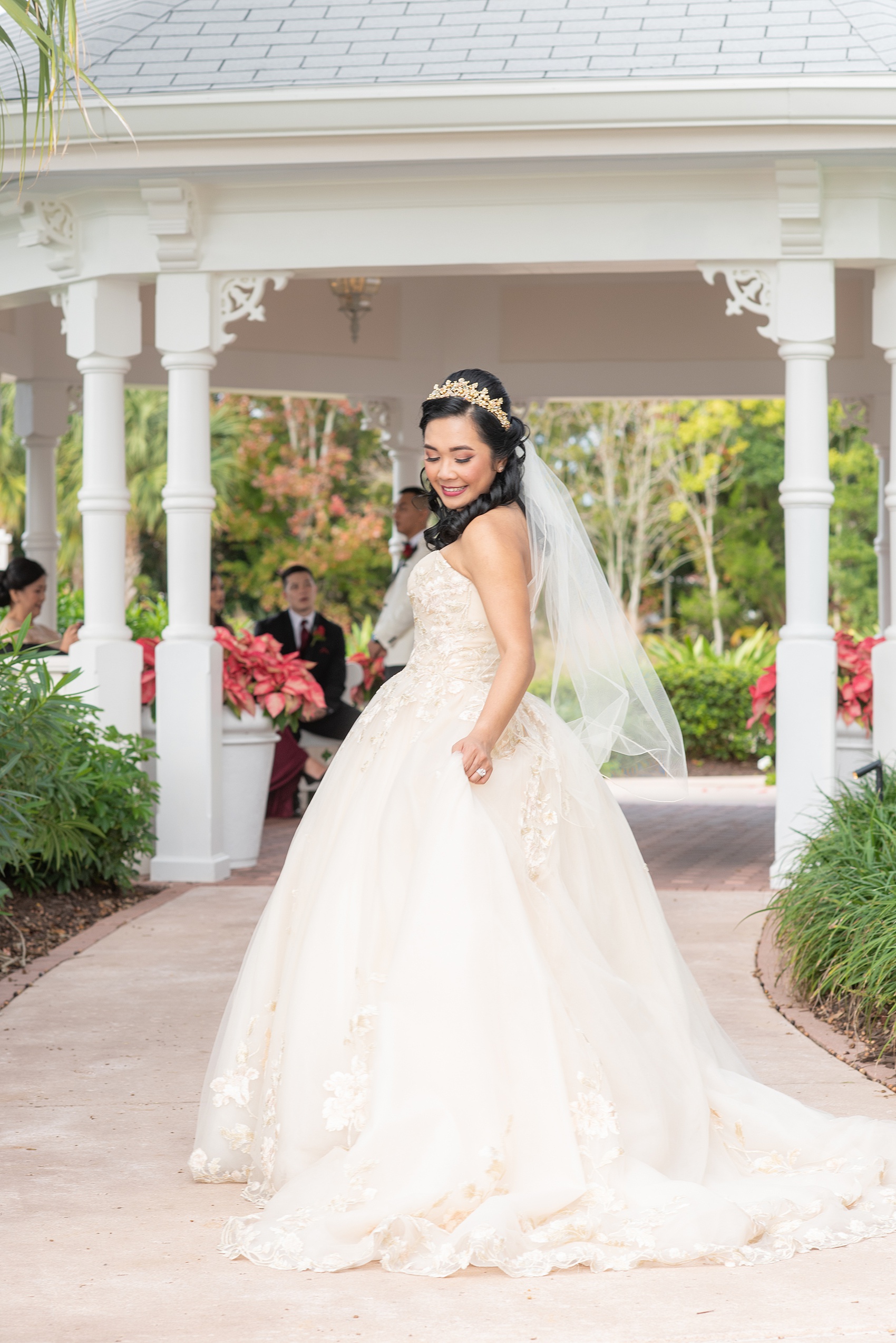 Photographs of a Walt Disney World bride by Mikkel Paige Photography. As a lover of Beauty and the Beast, the bride wove details from the classic Disney film into her wedding. Her beautiful rose embroidered dress was befitting of a princess. She got ready for her day at the dream resort, the Grand Floridian. Her hair was twisted into a fun, rose bun. #disneywedding #disneybride #waltdisneyworld #DisneyWorldWedding