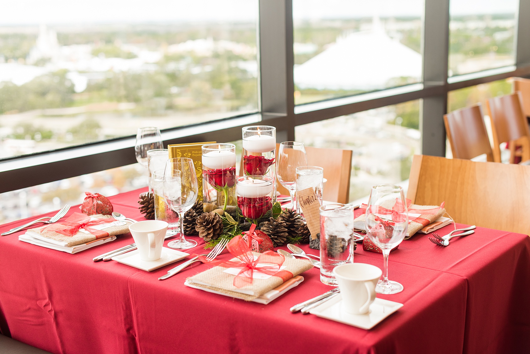 Walt Disney World photographs by Mikkel Paige Photography. The bride and groom had a dream December wedding at the Grand Floridian Resort, Wedding Pavilion and Contemporary Hotel. It had a Beauty and the Beast theme with books on the tables, small pine cones, and awesome red rose vases. The venue overlooked the Magic Kingdom with Cinderella Castle in the distance. #disneywedding #disneybride #waltdisneyworld #DisneyWorldWedding #CinderellaCastle #BeautyandtheBeastWedding