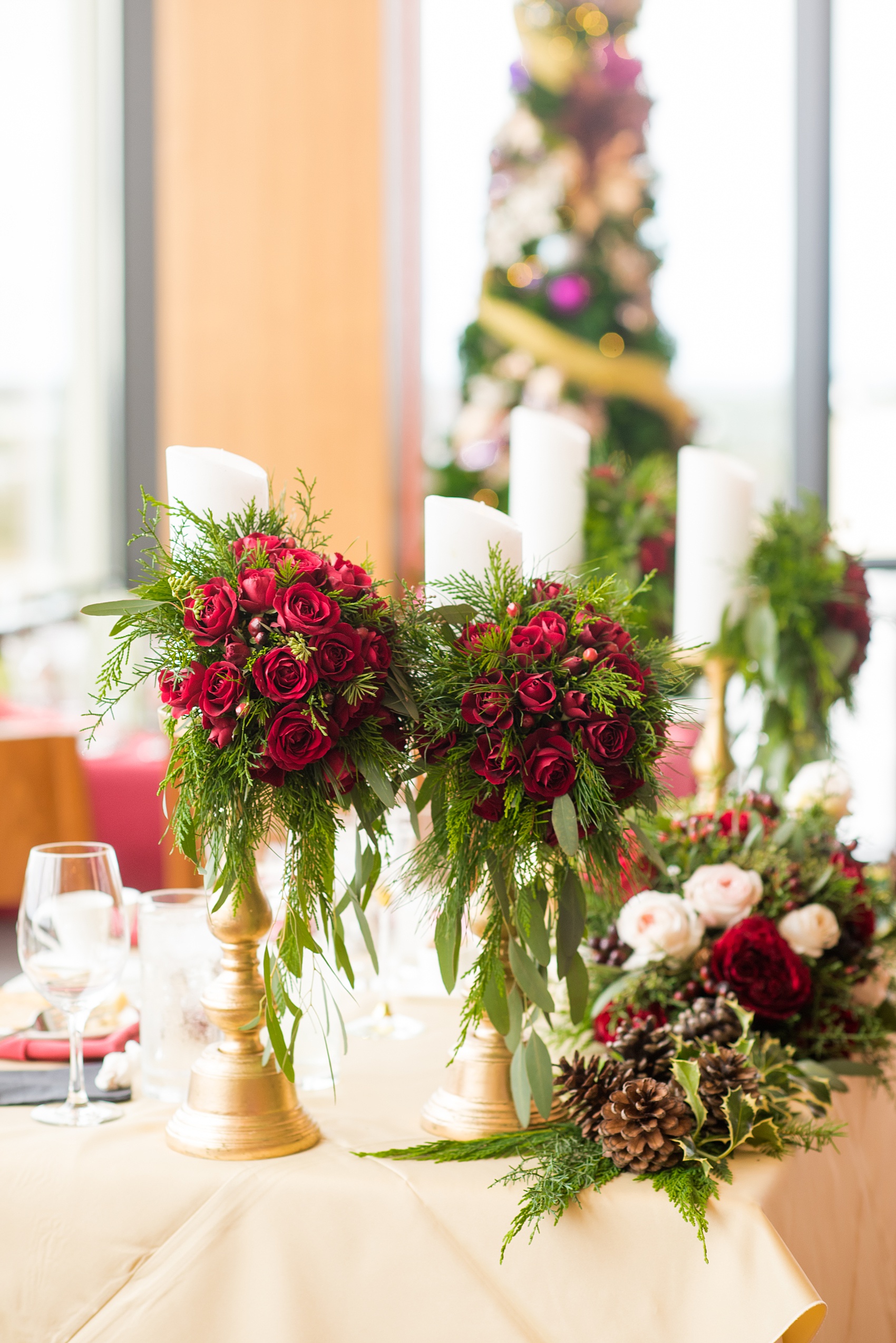 Walt Disney World photographs by Mikkel Paige Photography. The bride and groom had a dream December wedding at the Grand Floridian Resort, Wedding Pavilion and Contemporary Hotel. It had a Beauty and the Beast theme with books on the tables, small pine cones, and awesome red rose vases. The venue overlooked the Magic Kingdom with Cinderella Castle in the distance. #disneywedding #disneybride #waltdisneyworld #DisneyWorldWedding #CinderellaCastle #BeautyandtheBeastWedding