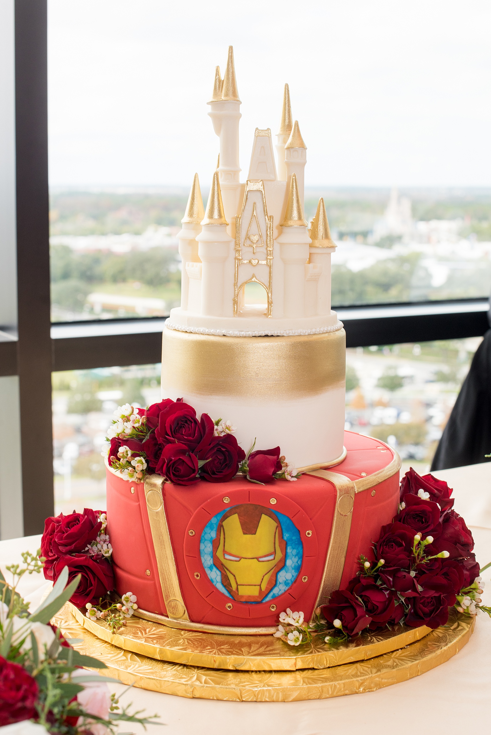Photographs of a Walt Disney World wedding by Mikkel Paige Photography will give you ideas for a tasteful theme. The bride and groom’s cake had red fondant with a Marvel Iron Man emblem. The top had a white chocolate Cinderella Castle with a brush of gold for a small reception celebration. #disneywedding #DisneyCake #DisneyWorldWedding #Disneyreception #californiagrill #ContemporaryResort #disneyweddingcake #MarvelWeddingCake #CinderellaCastleCake