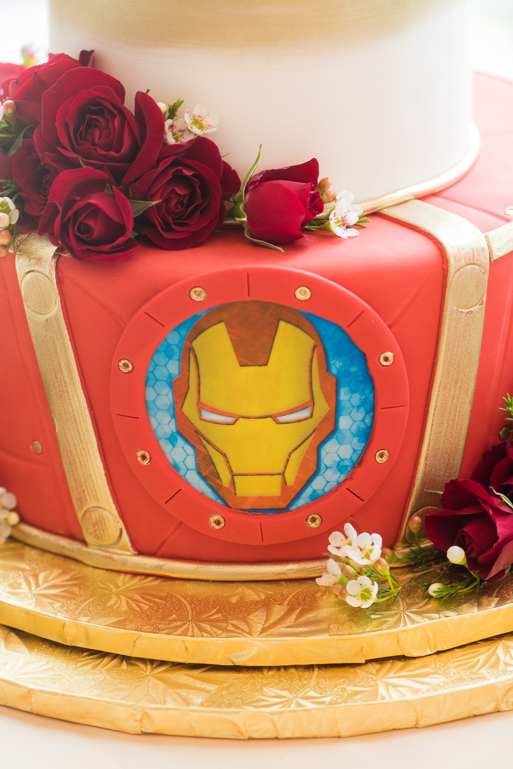 Photographs of a Walt Disney World wedding by Mikkel Paige Photography will give you ideas for a tasteful theme. The bride and groom’s cake had red fondant with a Marvel Iron Man emblem. The top had a white chocolate Cinderella Castle with a brush of gold for a small reception celebration. #disneywedding #DisneyCake #DisneyWorldWedding #Disneyreception #californiagrill #ContemporaryResort #disneyweddingcake #MarvelWeddingCake #CinderellaCastleCake