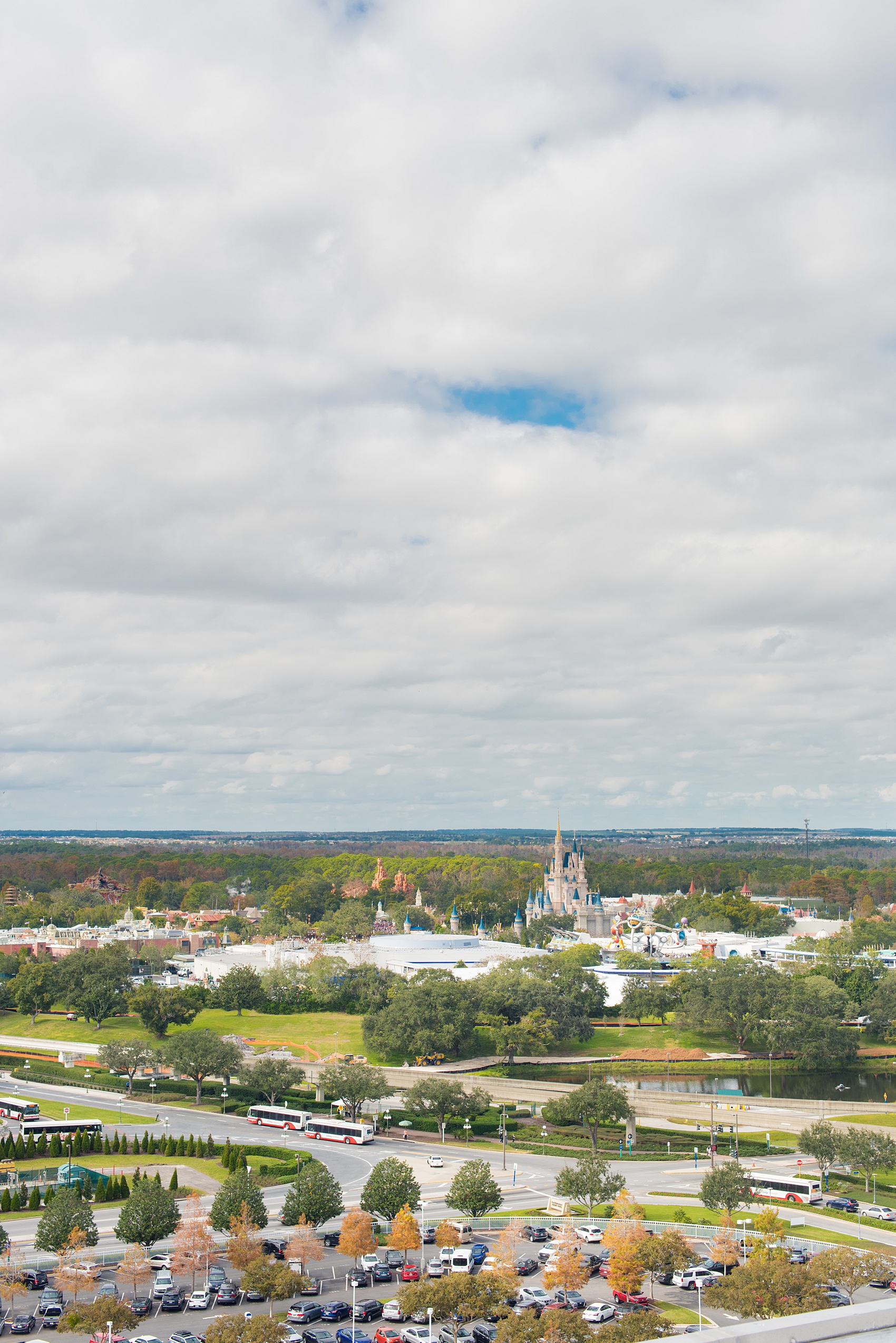 Walt Disney World photographs by Mikkel Paige Photography. The bride and groom had a dream December wedding at the Grand Floridian Resort, Wedding Pavilion and Contemporary Hotel. It had a Beauty and the Beast theme with books on the tables, small pine cones, and awesome red rose vases. The venue overlooked the Magic Kingdom with Cinderella Castle in the distance. #disneywedding #disneybride #waltdisneyworld #DisneyWorldWedding #CinderellaCastle #BeautyandtheBeastWedding