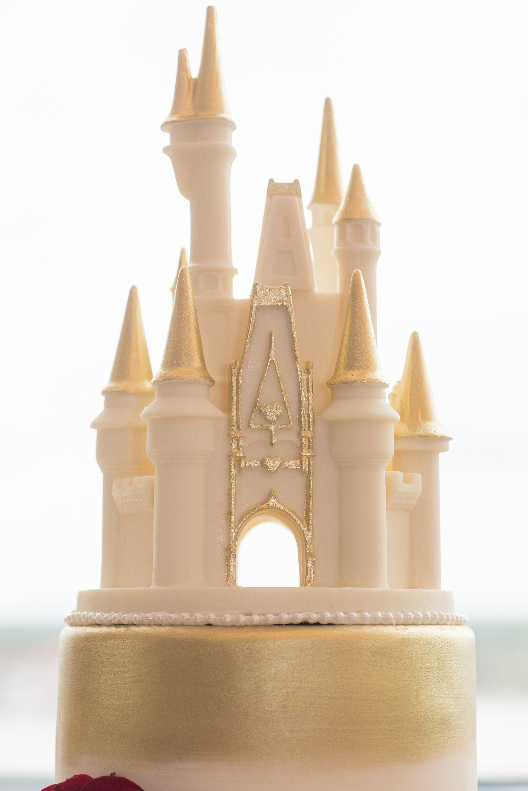 Photographs of a Walt Disney World wedding by Mikkel Paige Photography will give you ideas for a tasteful theme. The bride and groom’s cake had red fondant with a Marvel Iron Man emblem. The top had a white chocolate Cinderella Castle with a brush of gold for a small reception celebration. #disneywedding #DisneyCake #DisneyWorldWedding #Disneyreception #californiagrill #ContemporaryResort #disneyweddingcake #MarvelWeddingCake #CinderellaCastleCake