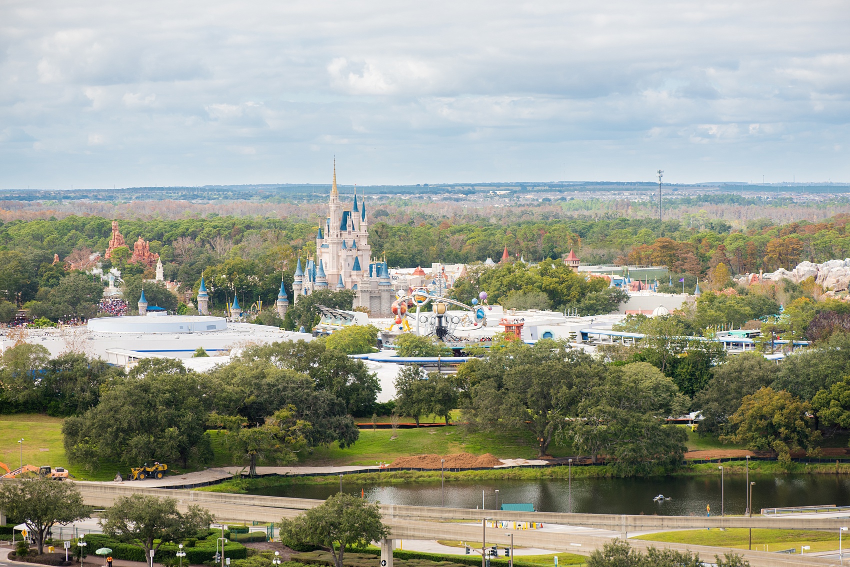 Walt Disney World photographs by Mikkel Paige Photography. The bride and groom had a dream December wedding at the Grand Floridian Resort, Wedding Pavilion and Contemporary Hotel. It had a Beauty and the Beast theme with books on the tables, small pine cones, and awesome red rose vases. The venue overlooked the Magic Kingdom with Cinderella Castle in the distance. #disneywedding #disneybride #waltdisneyworld #DisneyWorldWedding #CinderellaCastle #BeautyandtheBeastWedding