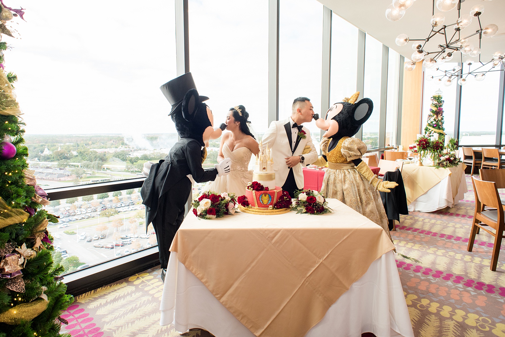Photographs of a Walt Disney World wedding by Mikkel Paige Photography. The bride and groom had cake cutting help from Mickey Mouse and Minnie Mouse in formal attire! Their reception venue at The Contemporary Resort’s California Grill was great for fun, awesome photos with them. It overlooked the Magic Kingdom Park and Cinderella Castle! Their small, dream day included red rose details and a Beauty and the Beast theme. #disneywedding #DisneyWorldWedding #BeautyandtheBeast #MickeyandMinnie