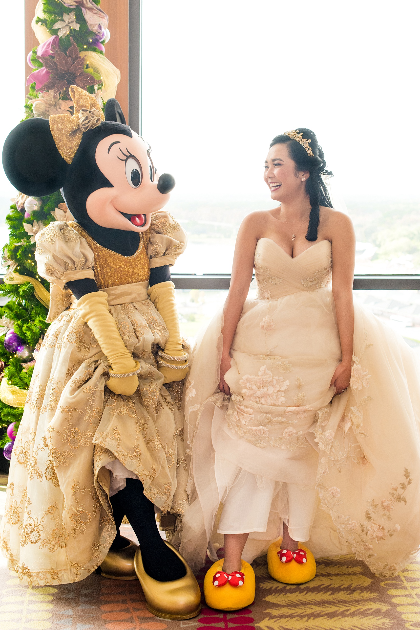 Photographs of a Walt Disney World wedding by Mikkel Paige Photography. The bride wore matching Minnie Mouse slippers to get ready and their photographer had the idea to do a cute Minnie Mouse and Bride matching shoe picture! The reception venue at The Contemporary Resort’s California Grill was great for fun, awesome photos with them. Their small, dream day overlooked the Magic Kingdom Park and Cinderella Castle! #disneywedding #DisneyWorldWedding #MinnieMouse