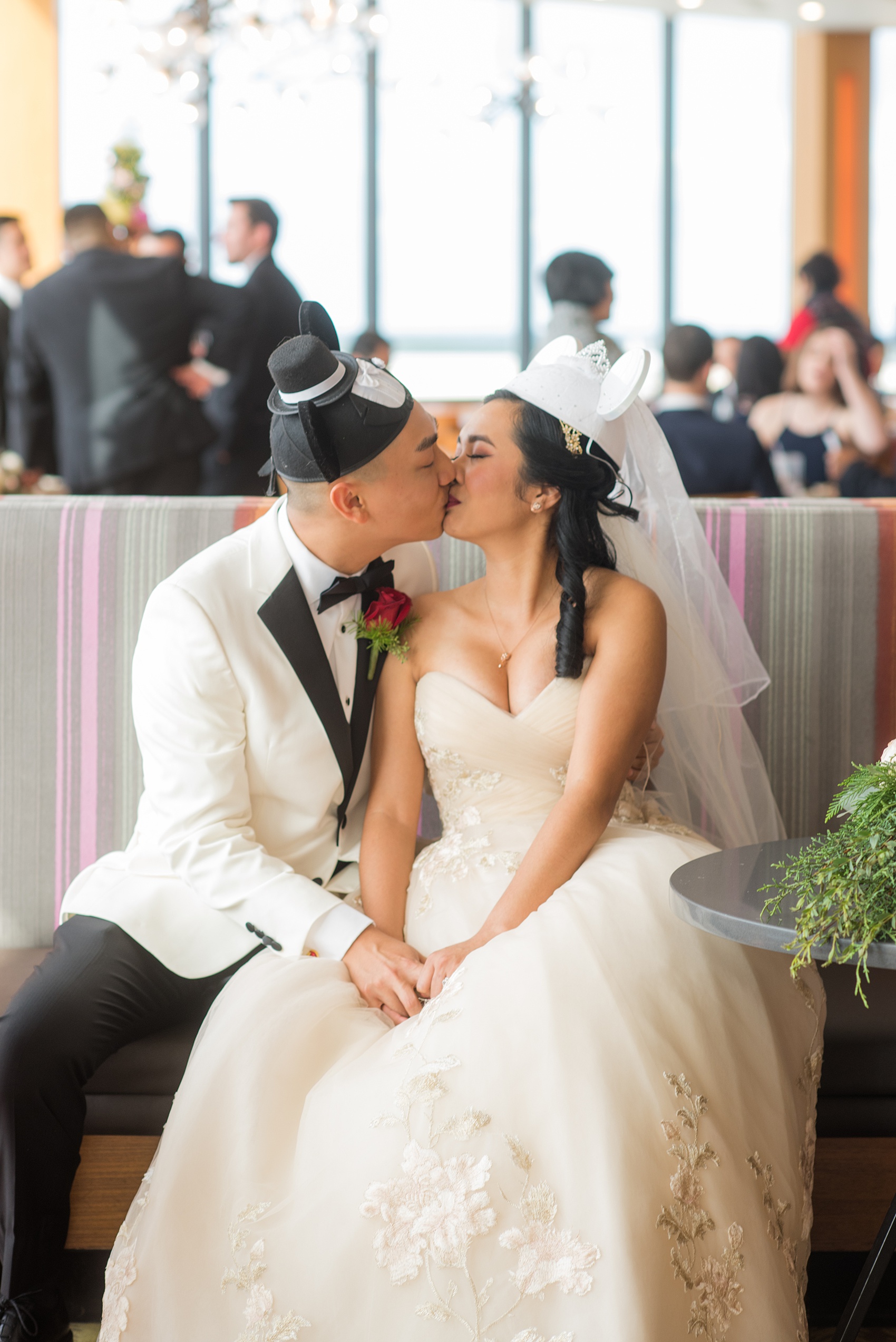 Walt Disney World photographs by Mikkel Paige Photography. The bride and groom had December pictures at the Grand Floridian Resort, Wedding Pavilion and Contemporary Hotel. They wore bride and groom Mickey and Minnie Mouse ears in this cute photo at the end of the reception celebration. #disneywedding #disneybride #waltdisneyworld #DisneyWorldWedding #MickeyEarPictures #mickeyears #mickeyandminnieears