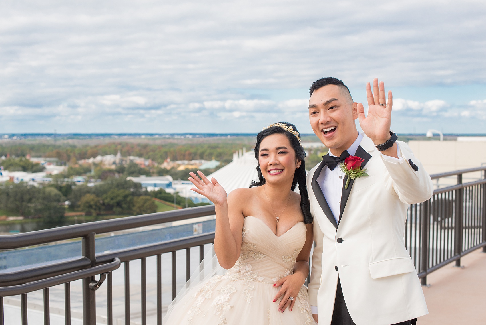 Walt Disney World photographs by Mikkel Paige Photography. The bride and groom had December pictures at the Grand Floridian Resort, Wedding Pavilion and Contemporary Hotel. It had a Beauty and the Beast theme and the bride wore a beautiful rose embroidered dress, befitting of a princess. Her red rose bouquet had holiday greenery and a cascading effect. The groom wore a white tuxedo. #disneywedding #disneybride #waltdisneyworld #DisneyWorldWedding #cascadingbouquet