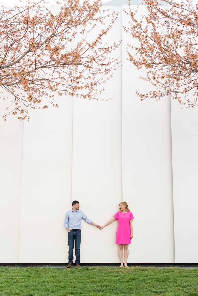 Beautiful pictures of an engagement session at the North Carolina Museum of Art, NCMA by Raleigh North Carolina wedding photographer, Mikkel Paige Photography. They brought their Golden Doodle dog for extra fun and we captured the Cherry Blossoms during a spring photoshoot. | Raleigh Engagement Photographer | #mikkelpaige #RaleighEngagementPhotographer #RaleighEngagementPhotographs