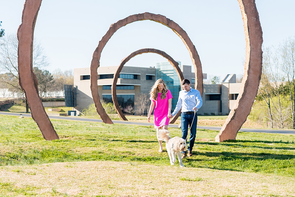 Beautiful pictures of an engagement session at the North Carolina Museum of Art, NCMA by Raleigh North Carolina wedding photographer, Mikkel Paige Photography. They brought their Golden Doodle dog for extra fun and we captured the Cherry Blossoms during a spring photoshoot. | Raleigh Engagement Photographer | #mikkelpaige #RaleighEngagementPhotographer #RaleighEngagementPhotographs