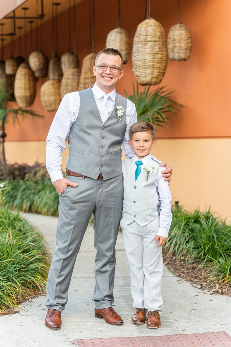 Hub 925 wedding photos at an alternative Orlando wedding venue by Mikkel Paige Photography. The groom wore a grey vest instead of a suit or tuxedo at his April celebration and posed with the ring bearer near Universal theme park. #mikkelpaige #hub925 #orlandoweddingphotographer #orlandoweddingphotos #floridaweddingphotographer #centralfloridawedding #orlandoweddingvenue #groomstyle #ringbearer