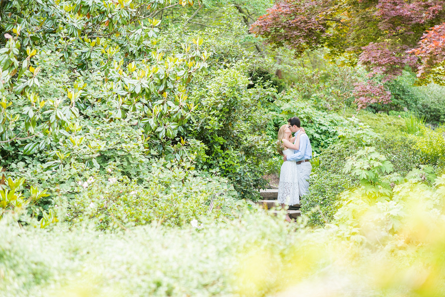 Duke Gardens engagement photos in Durham, North Carolina, by Mikkel Paige Photography. Trees with leaves in full bloom during spring reveal themselves for a May session. #DurhamPhotographer #DurhamWeddingPhotographer #SarahPDukeGardens #DukeGardens #DurhamEngagementSession