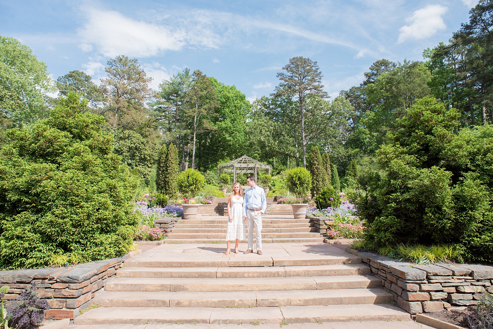 Duke Gardens engagement photos in Durham, North Carolina, by Mikkel Paige Photography. Trees with leaves in full bloom during spring reveal themselves for a May session. #DurhamPhotographer #DurhamWeddingPhotographer #SarahPDukeGardens #DukeGardens #DurhamEngagementSession