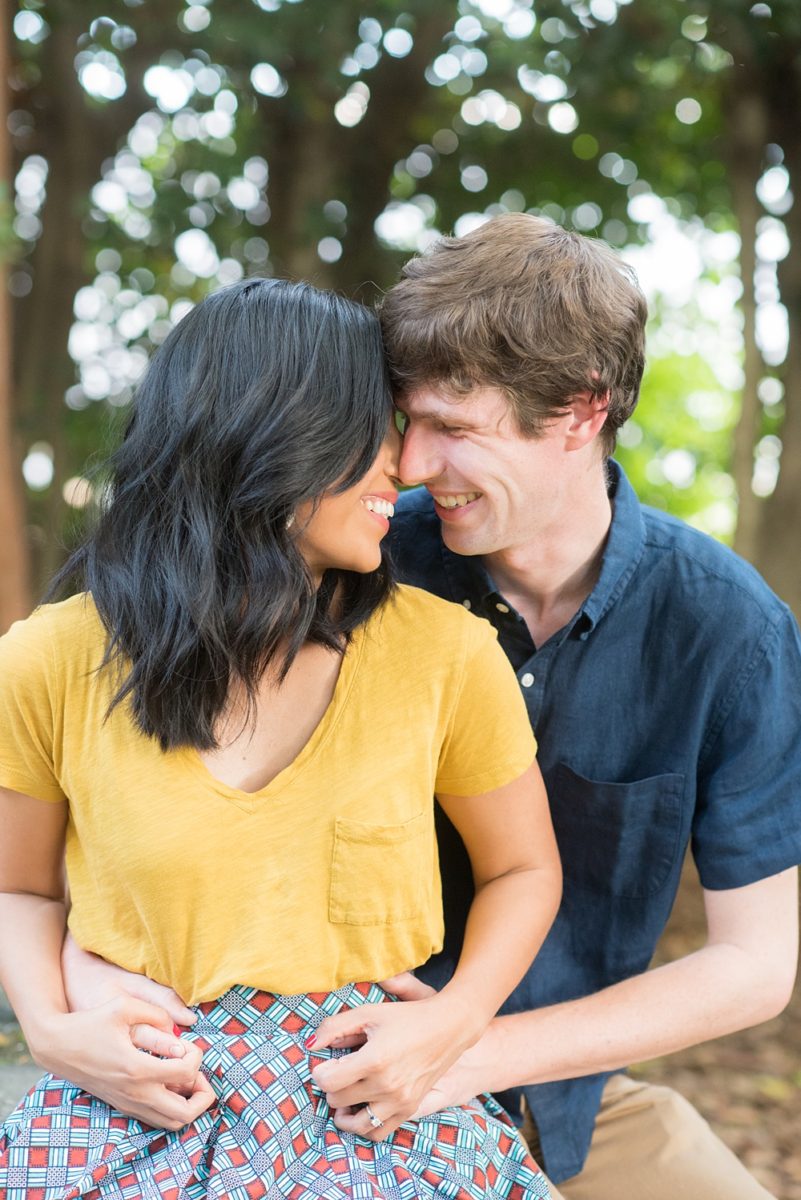 Raleigh engagement photos with murals and spring flowers in the downtown area by Mikkel Paige Photography. The bride and groom choose JC Raulston Arboretum and the Marbles Kids Museum mural for their pictures. #DowntownRaleigh #RaleighWeddingPhotographer #mikkelpaige #RaleighPhotographer #RaleighPhotos #RaleighNC #NorthCarolinaPhotographer