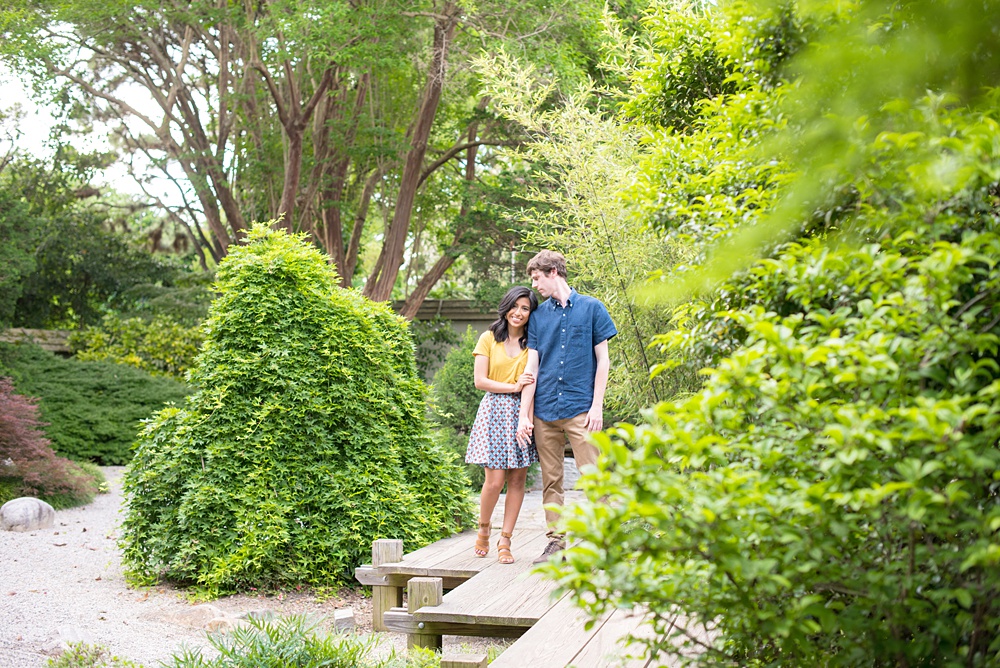 Raleigh engagement photos with murals and spring flowers in the downtown area by Mikkel Paige Photography. The bride and groom choose JC Raulston Arboretum and the Marbles Kids Museum mural for their pictures. #DowntownRaleigh #RaleighWeddingPhotographer #mikkelpaige #RaleighPhotographer #RaleighPhotos #RaleighNC #NorthCarolinaPhotographer