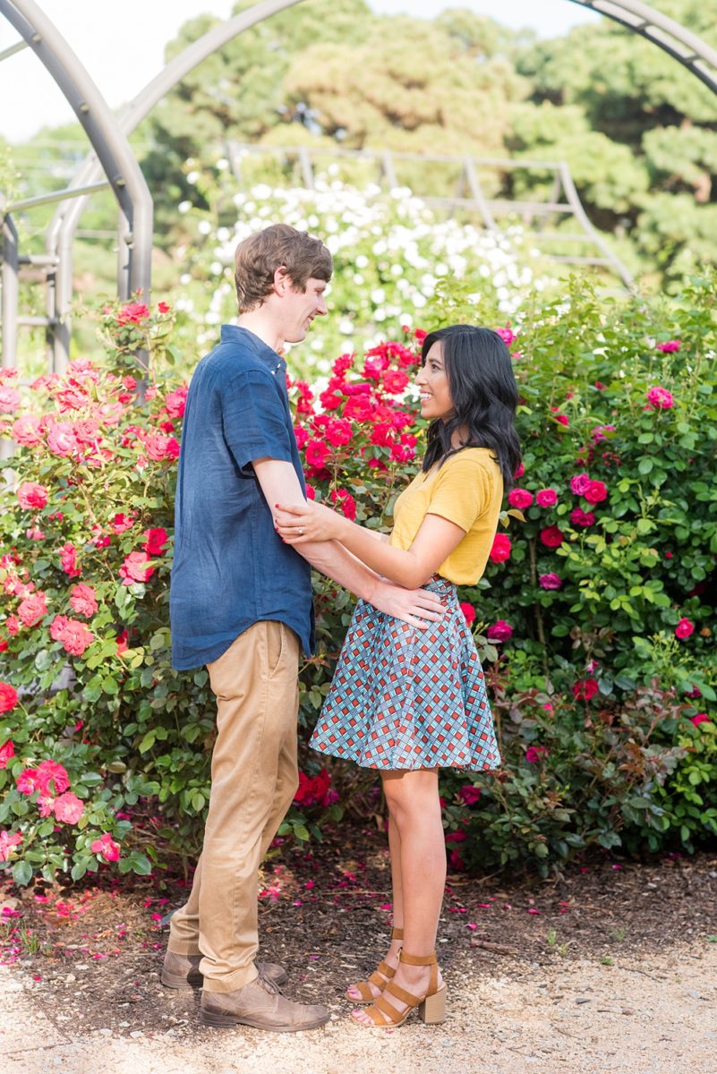 Raleigh engagement photos with murals and spring flowers in the downtown area by Mikkel Paige Photography. The bride and groom choose JC Raulston Arboretum and the Marbles Kids Museum mural for their pictures. #DowntownRaleigh #RaleighWeddingPhotographer #mikkelpaige #RaleighPhotographer #RaleighPhotos #RaleighNC #NorthCarolinaPhotographer