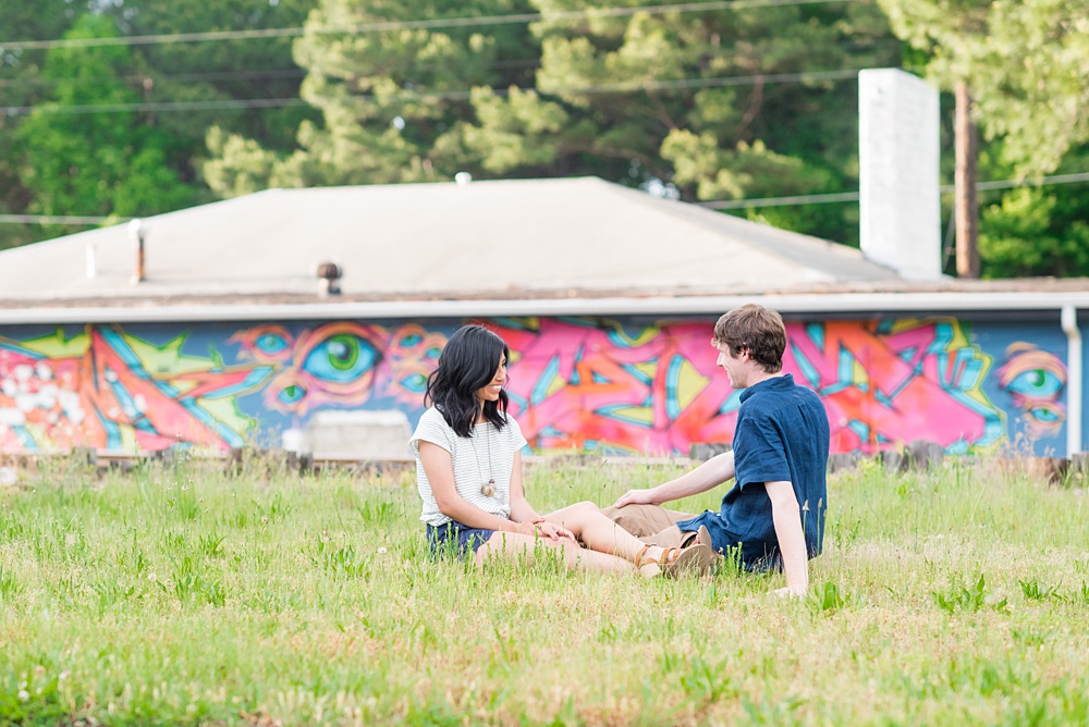 Raleigh engagement photos with murals and spring flowers in the downtown area by Mikkel Paige Photography. The bride and groom choose JC Raulston Arboretum and the Marbles Kids Museum mural for their pictures. #DowntownRaleigh #RaleighWeddingPhotographer #mikkelpaige #RaleighPhotographer #RaleighPhotos #RaleighNC #NorthCarolinaPhotographer