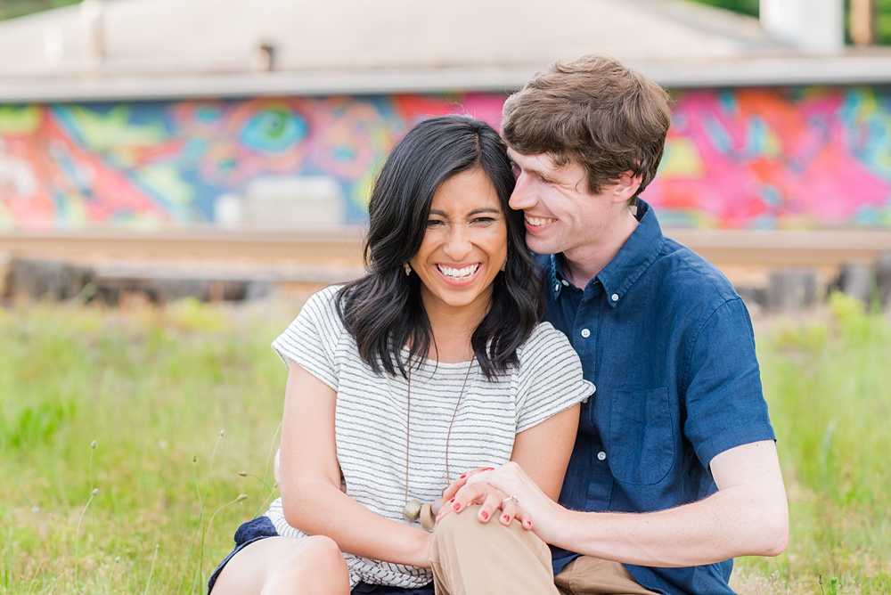 Raleigh engagement photos with murals and spring flowers in the downtown area by Mikkel Paige Photography. The bride and groom choose JC Raulston Arboretum and the Marbles Kids Museum mural for their pictures. #DowntownRaleigh #RaleighWeddingPhotographer #mikkelpaige #RaleighPhotographer #RaleighPhotos #RaleighNC #NorthCarolinaPhotographer