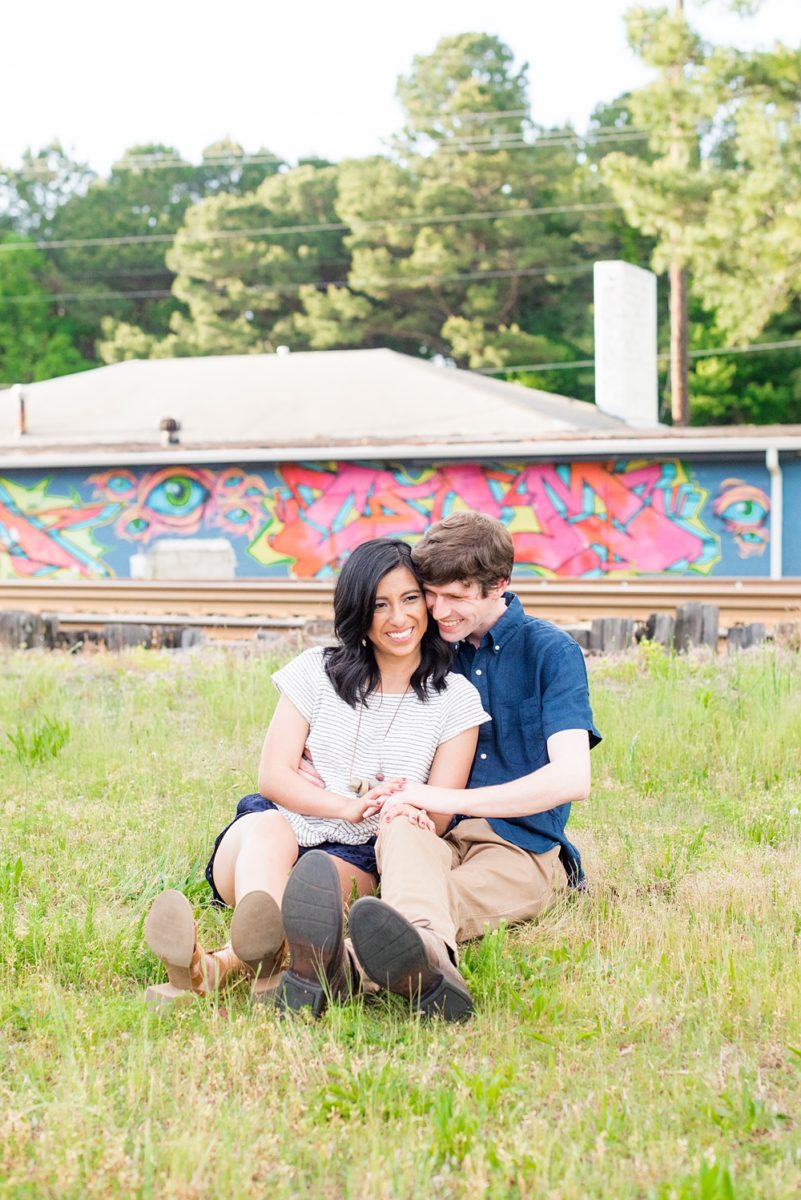 Raleigh engagement photos with murals and spring flowers in the downtown area by Mikkel Paige Photography. The bride and groom choose JC Raulston Arboretum and the Marbles Kids Museum mural for their pictures. #DowntownRaleigh #RaleighWeddingPhotographer #mikkelpaige #RaleighPhotographer #RaleighPhotos #RaleighNC #NorthCarolinaPhotographer