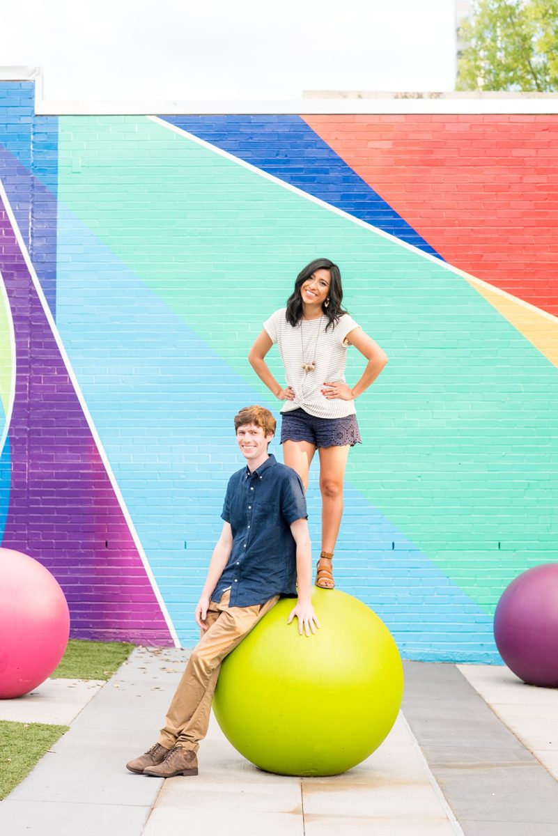 Raleigh engagement photos with murals and spring flowers in the downtown area by Mikkel Paige Photography. The bride and groom choose JC Raulston Arboretum and the Marbles Kids Museum mural for their pictures. #DowntownRaleigh #RaleighWeddingPhotographer #mikkelpaige #RaleighPhotographer #RaleighPhotos #RaleighNC #NorthCarolinaPhotographer