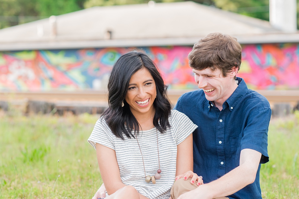 Raleigh engagement photos with murals and spring flowers in the downtown area by Mikkel Paige Photography. The bride and groom choose JC Raulston Arboretum and the Marbles Kids Museum mural for their pictures. #DowntownRaleigh #RaleighWeddingPhotographer #mikkelpaige #RaleighPhotographer #RaleighPhotos #RaleighNC #NorthCarolinaPhotographer