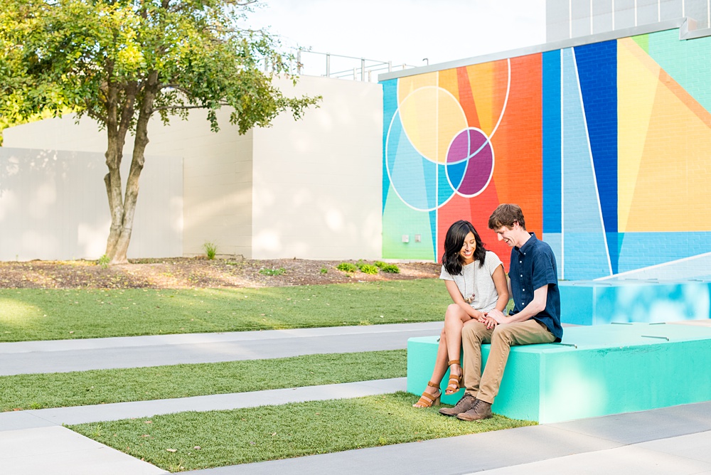 Raleigh engagement photos with murals and spring flowers in the downtown area by Mikkel Paige Photography. The bride and groom choose JC Raulston Arboretum and the Marbles Kids Museum mural for their pictures. #DowntownRaleigh #RaleighWeddingPhotographer #mikkelpaige #RaleighPhotographer #RaleighPhotos #RaleighNC #NorthCarolinaPhotographer