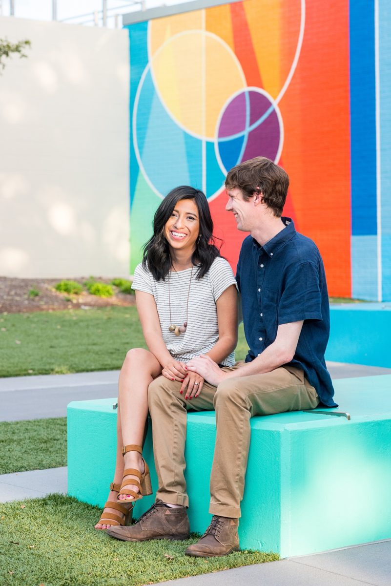 Raleigh engagement photos with murals and spring flowers in the downtown area by Mikkel Paige Photography. The bride and groom choose JC Raulston Arboretum and the Marbles Kids Museum mural for their pictures. #DowntownRaleigh #RaleighWeddingPhotographer #mikkelpaige #RaleighPhotographer #RaleighPhotos #RaleighNC #NorthCarolinaPhotographer