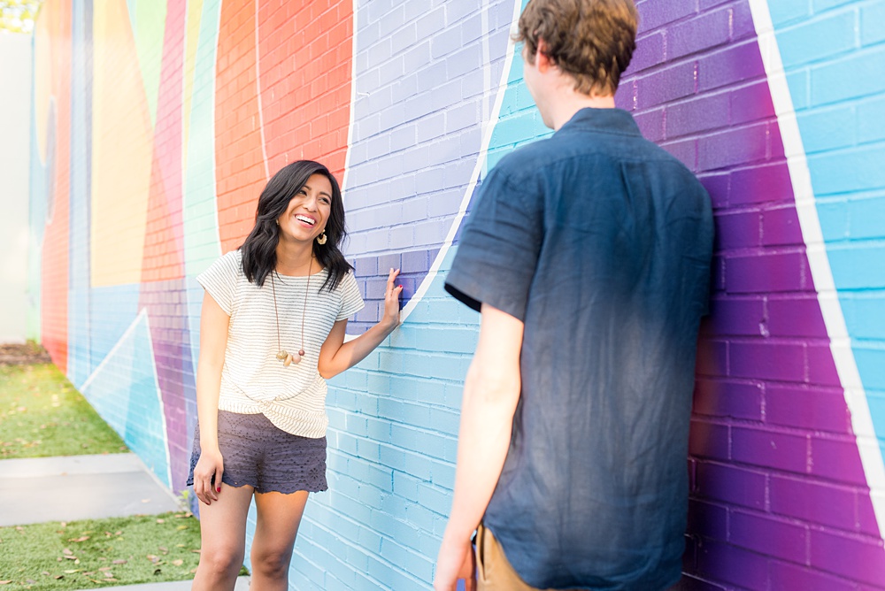 Raleigh engagement photos with murals and spring flowers in the downtown area by Mikkel Paige Photography. The bride and groom choose JC Raulston Arboretum and the Marbles Kids Museum mural for their pictures. #DowntownRaleigh #RaleighWeddingPhotographer #mikkelpaige #RaleighPhotographer #RaleighPhotos #RaleighNC #NorthCarolinaPhotographer