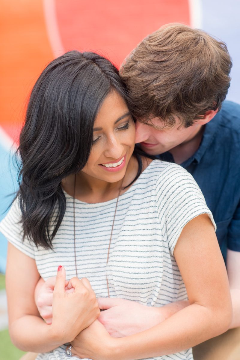 Raleigh engagement photos with murals and spring flowers in the downtown area by Mikkel Paige Photography. The bride and groom choose JC Raulston Arboretum and the Marbles Kids Museum mural for their pictures. #DowntownRaleigh #RaleighWeddingPhotographer #mikkelpaige #RaleighPhotographer #RaleighPhotos #RaleighNC #NorthCarolinaPhotographer