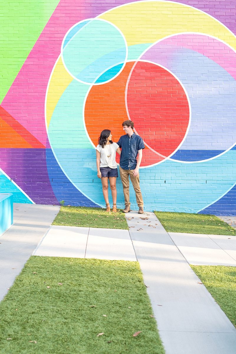 Raleigh engagement photos with murals and spring flowers in the downtown area by Mikkel Paige Photography. The bride and groom choose JC Raulston Arboretum and the Marbles Kids Museum mural for their pictures. #DowntownRaleigh #RaleighWeddingPhotographer #mikkelpaige #RaleighPhotographer #RaleighPhotos #RaleighNC #NorthCarolinaPhotographer