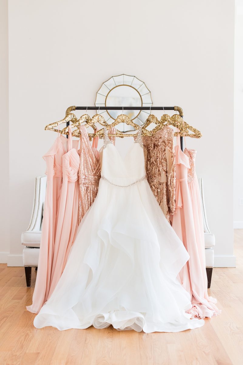 Detail picture of a Hayley Paige wedding gown with pink shades of bridesmaids dresses and sequin gowns. The wedding was at the event venue The Stockroom at 230 and The Glass Box, in downtown Raleigh, North Carolina. Mikkel Paige Photography captured inspiring bride, groom and wedding portraits and reception pictures of their hot pink and aqua blue colors. #MikkelPaige #DowntownRaleigh #RaleighWedding #RaleighVenue #TheStockroomat230