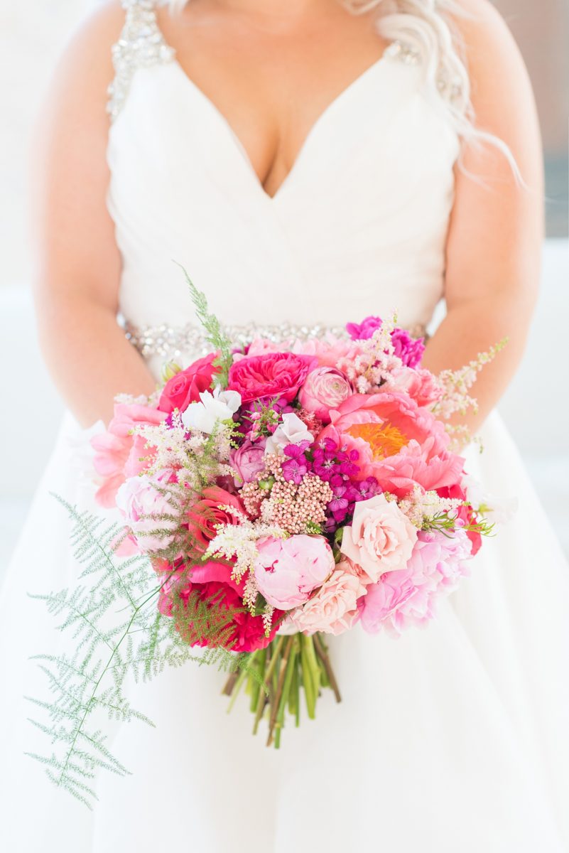 A beautiful spring wedding in Raleigh, North Carolina, at the event venue, The Stockroom at 230 and The Glass Box. Their photographer, Mikkel Paige Photography, captured inspiring bride and groom wedding portraits at the capital building downtown. Their hot pink and aqua colors and peony bouquet perfect for May. #MikkelPaige #DowntownRaleigh #RaleighWedding #RaleighVenue #TheStockroomat230 #theenglishgardenraleigh