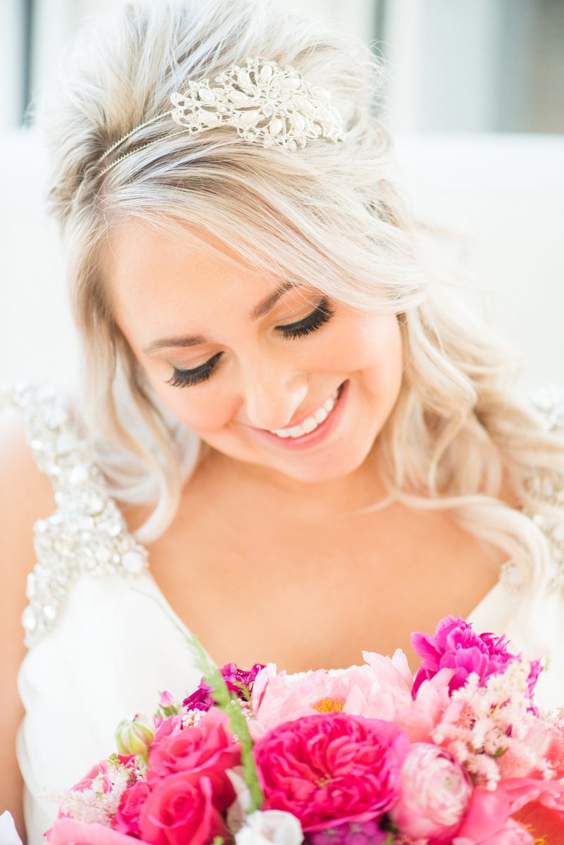 A beautiful spring wedding in Raleigh, North Carolina, at the event venue, The Stockroom at 230 and The Glass Box. Pictures of the bride getting ready with her yorkie dog by their photographer, Mikkel Paige Photography. Their hot pink and aqua colors were perfect for May as the bridesmaids celebrated with a champagne toast in floral robes. #MikkelPaige #DowntownRaleigh #RaleighWedding #RaleighVenue #TheStockroomat230 #bridesmaidsrobes #weddinggettingready