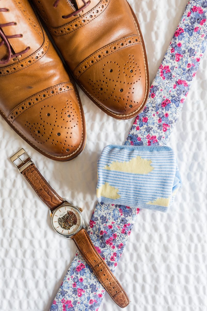 Raleigh wedding photographer, Mikkel Paige Photography, pictures of the groom and his groomsmen in blue suits with floral ties in downtown Raleigh, North Carolina at the event venue The Stockroom at 230 and capital building. The bright colors and hot pink boutonnieres were perfect for a spring May celebration. #MikkelPaige #DowntownRaleigh #RaleighWedding #RaleighVenue #TheStockroomat230 #capitalcity #groomsmen #boutonnieres #bluesuits #floraties #groomstyle #layflatphotography